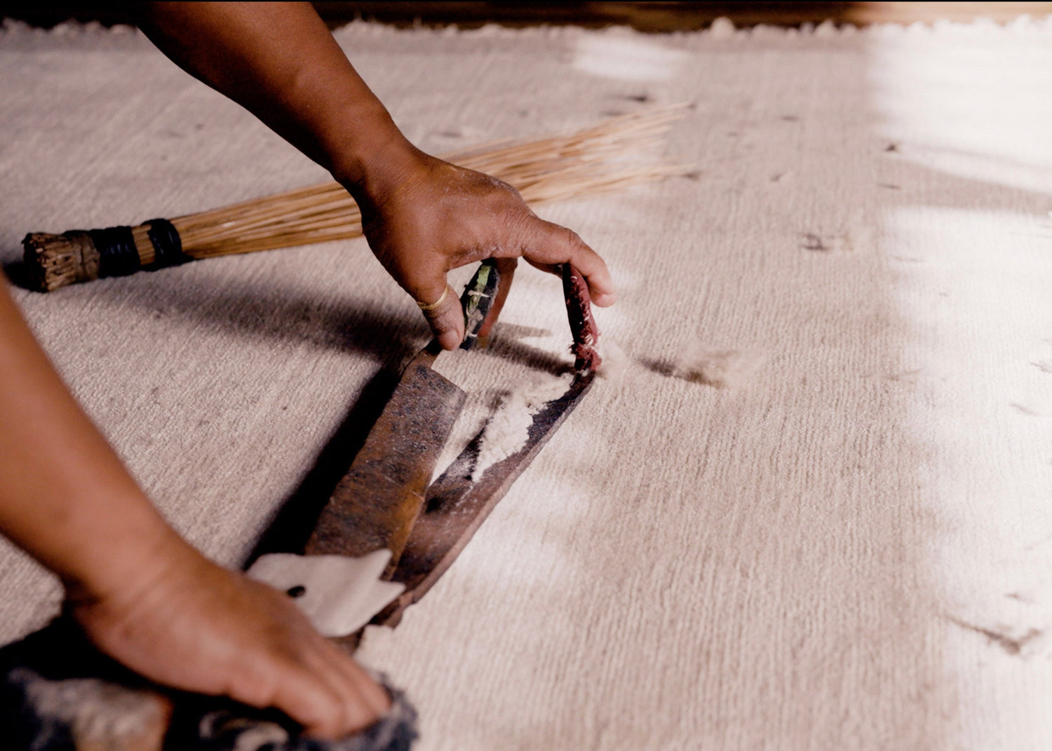a wool and silk rug is clipped by hand - traditional handcraft
