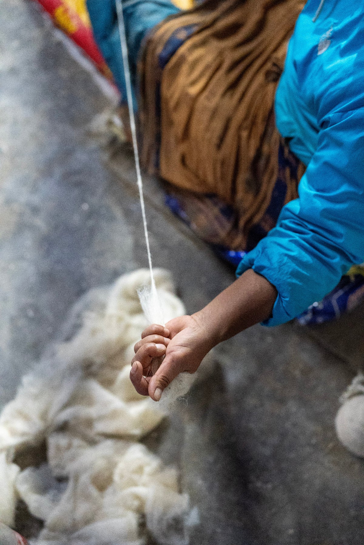 Women spinning wool for rugs by hand - traditional handcraft