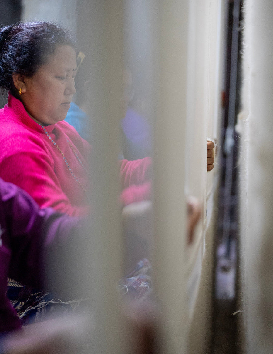 Women knotting a luxurious silk carpet by hand